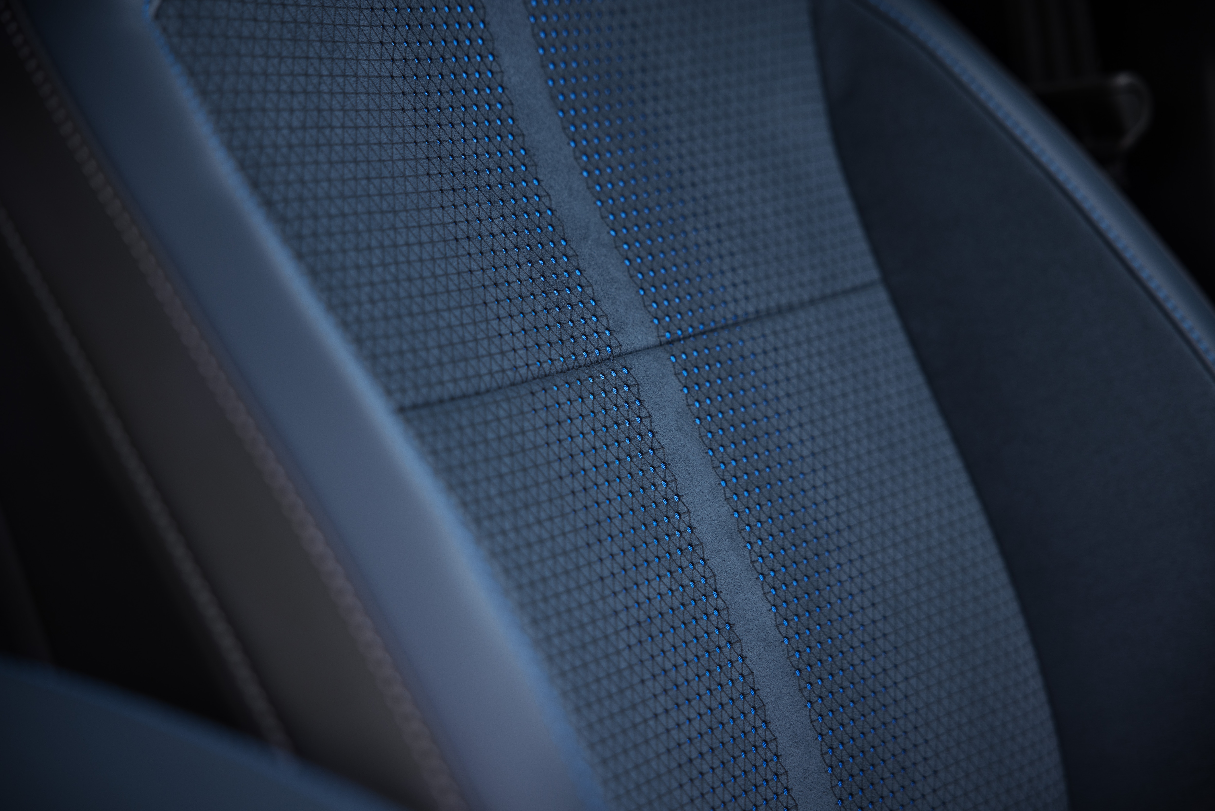 Close-up of Mustang Mach-E interior showing black and blue seat material and grey stitching.